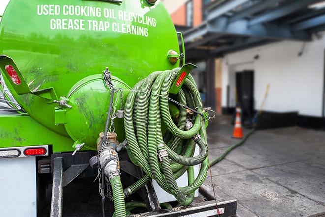 heavy-duty vacuum truck pumping out a grease trap in Essex, MA